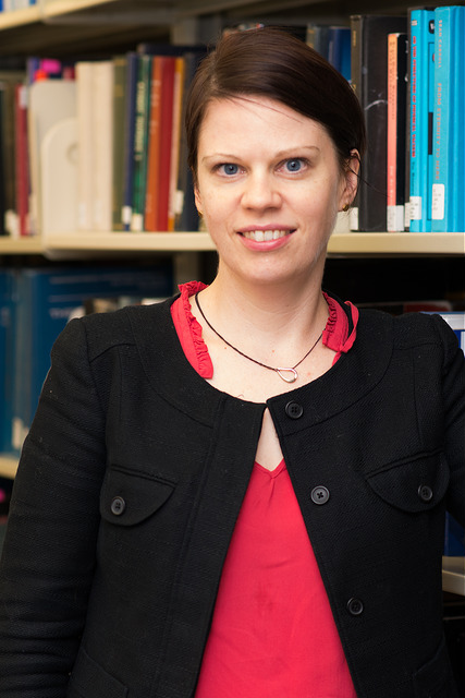 Elise Ferer stands in front of the stacks in the W. W. Hagerty Library